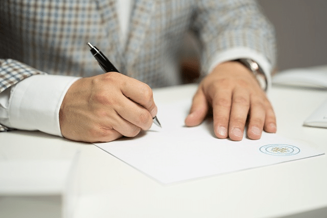 A person signing a loan agreement for same day loan